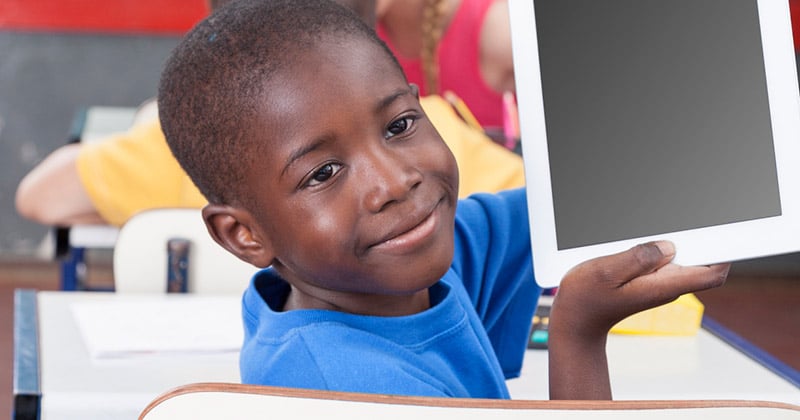 African boy showing a computer tablet