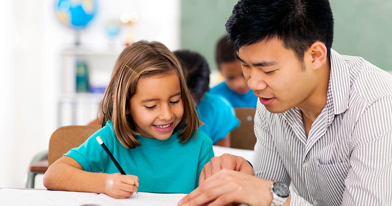 Classroom teacher instructing student