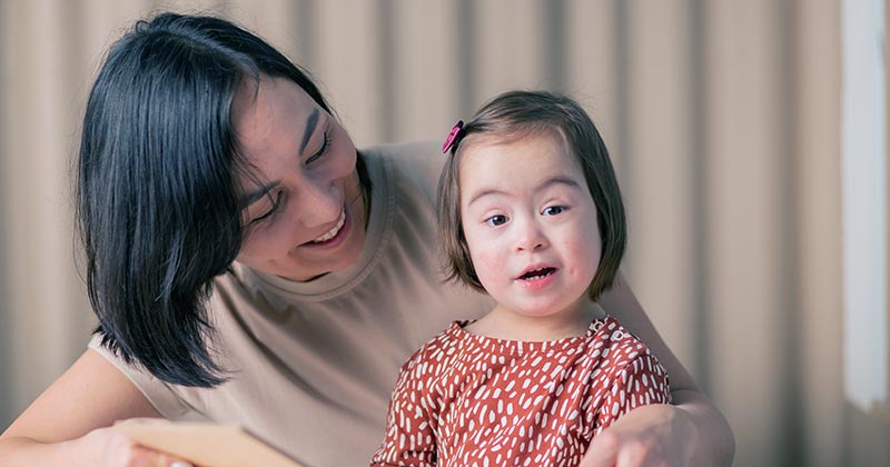 Teacher helping disadvantaged student