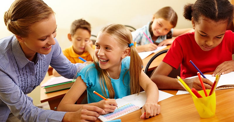 Teacher laughing with kids